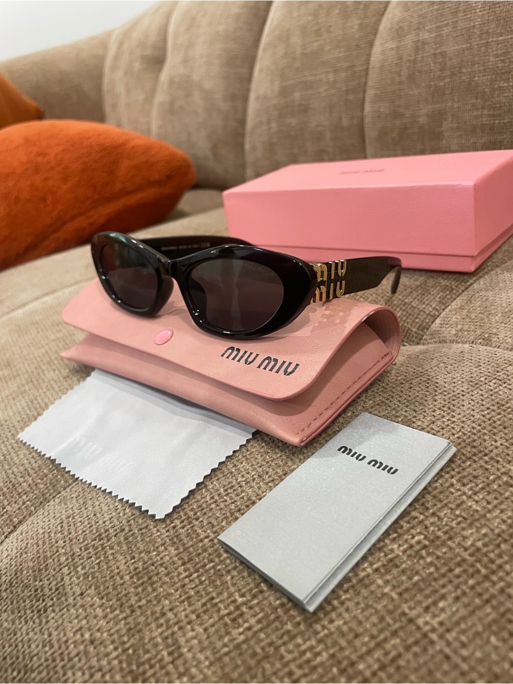 Miu Miu Black Cat-Eye Sunglasses with Gold Accent Logo